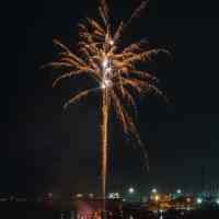 golden fireworks over waterfront in uk